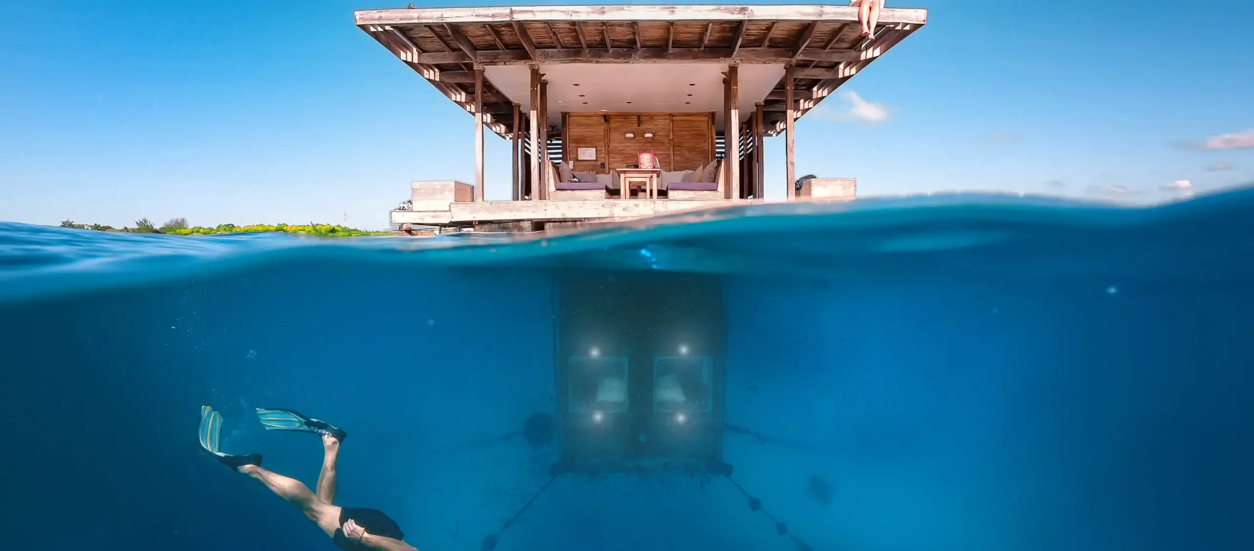 The Manta Resort's underwater room beneath the surface off Pemba Island, with a snorkeller above